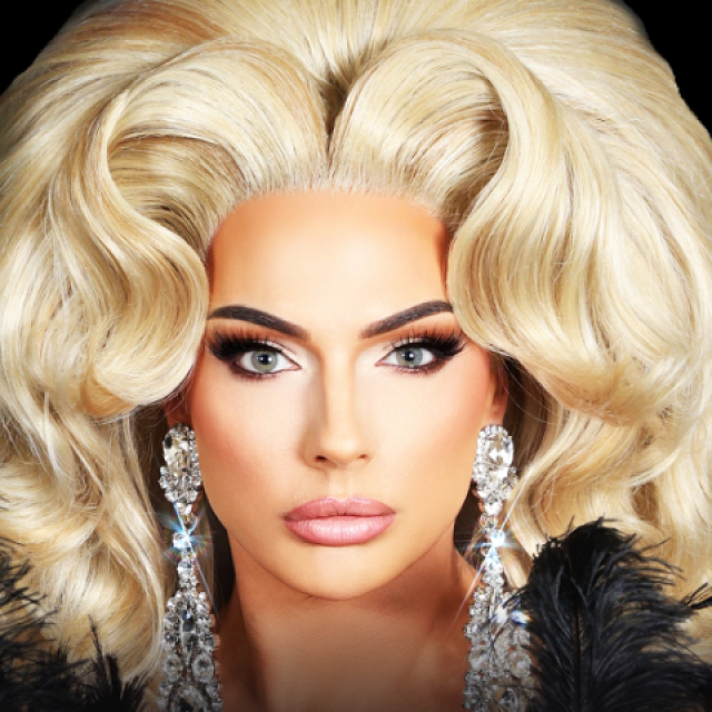 Promotional banner featuring seven individuals in dramatic drag-inspired makeup and elaborate hairstyles, arranged side-by-side against a black background. Each portrait showcases distinct styling, including platinum blonde, black, orange, and red hair, bold eye makeup, statement earrings, jeweled headpieces, and brightly colored fashion accents.